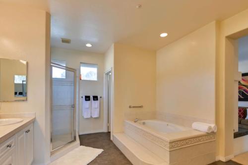 a large bathroom with a tub and a shower at Coastal Haven in Encinitas