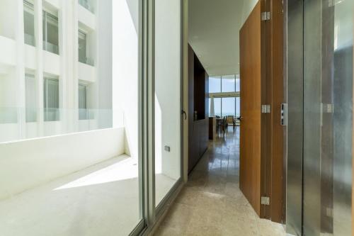 a hallway of a building with a glass wall at Temporada B52 in Telchac Puerto
