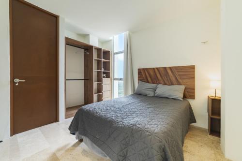 a bedroom with a large bed and a door at Temporada B52 in Telchac Puerto