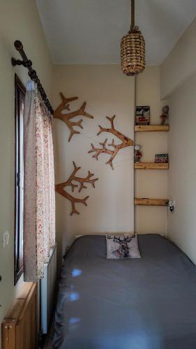 a bedroom with a bed with birds on the wall at PineNpeak in Arachova