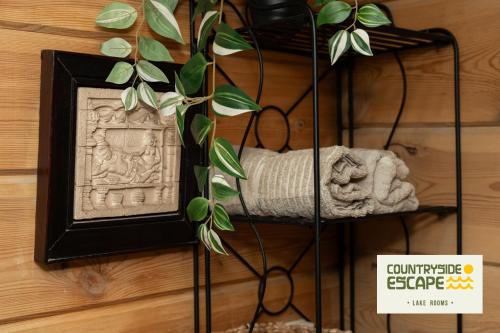 a shelf with a plant and a sign on a wall at Countryside Escape - Lake Rooms in Trakai