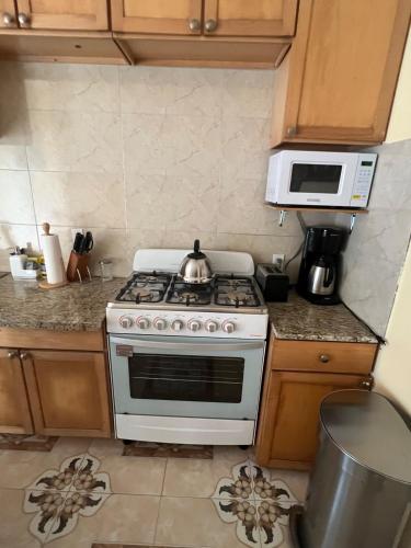 a kitchen with a stove and a microwave at Steps Away from Adventure -2bedroom & 1 Bath in Turtle Cove