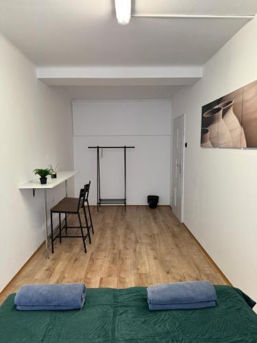 a bedroom with a bed and a table and a desk at Nice rooms in City Center Kraków in Kraków