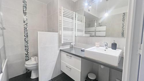 une salle de bain blanche avec un lavabo et des toilettes dans l'établissement La Bella Terrazza, à Nice