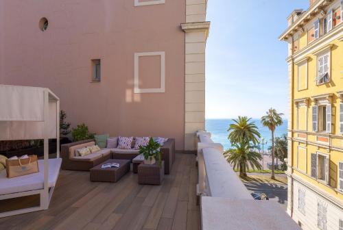 a balcony with a view of the ocean on a building at Hotel Beau Rivage in Nice