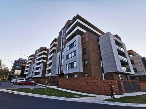 a man is standing in front of a building at Archer Apartment 2br with free car space in Kingston