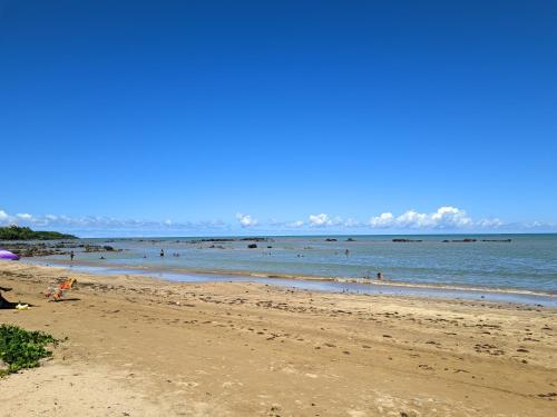 a beach with a bunch of people in the water at Pousada dos Veleiros in Nova Almeida
