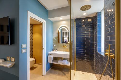 a bathroom with a sink and a shower at Ambasciatori Suite Hotel in Sottomarina