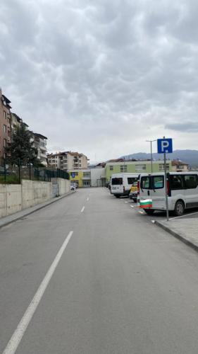 a parking lot with cars parked on the side of a street at Мезонет “Djanina” in Sandanski