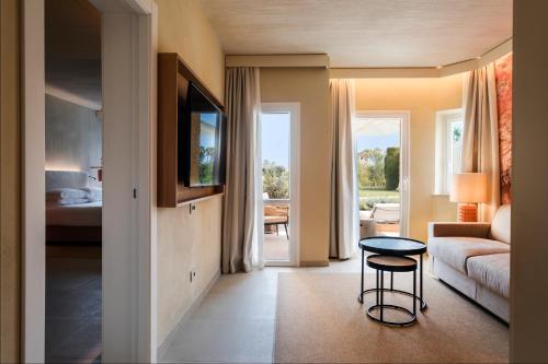 a living room with a couch and a chair in a room at Mangia's Brucoli, Sicily, Autograph Collection in Brucoli