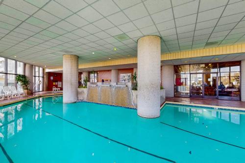 a swimming pool with blue water in a building at Sugar Top 2524 in Sugar Mountain