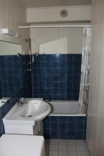 une salle de bain avec un lavabo, des toilettes et une baignoire dans l'établissement Magnolia, à Perros-Guirec