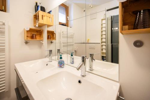 a bathroom with a white sink and a mirror at Gästehaus Tanja & Claus in Eisenstadt