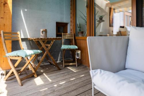 a room with two chairs and a table and a couch at Gästehaus Tanja & Claus in Eisenstadt