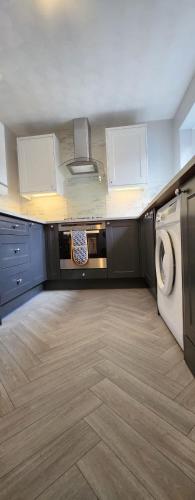 a kitchen with a washing machine and a washer at Sea Glass Cottage in Sunderland