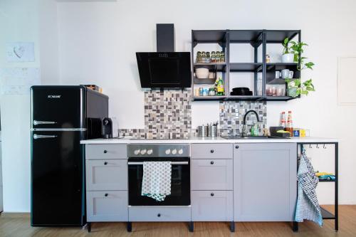 a kitchen with a black refrigerator and a stove at Gästehaus Tanja & Claus in Eisenstadt
