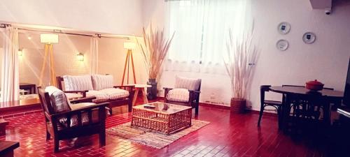 a living room with a couch and chairs and a table at Posada los Cedros in La Cumbre