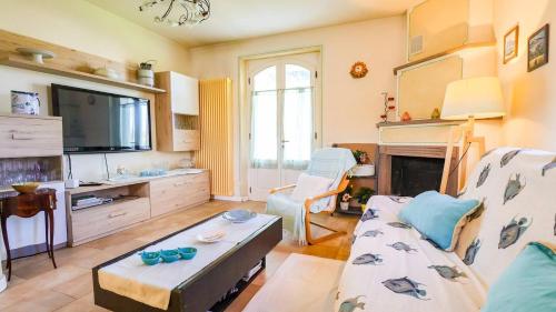 a living room with a couch and a tv at Forte dei Marmi House - with Jacuzzi in Cinquale