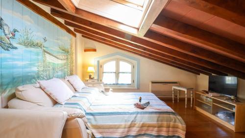 a bedroom with a bed and a skylight at Forte dei Marmi House - with Jacuzzi in Cinquale