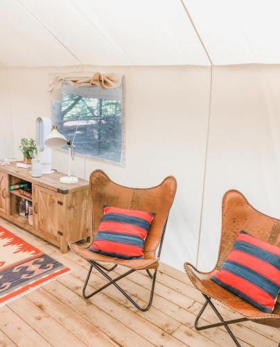 two chairs sitting in a room with a desk at Haida Gwaii Glamping in Tlell
