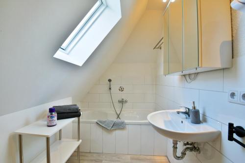 a bathroom with a sink and a bath tub at Parkvilla Köhler in Zella-Mehlis