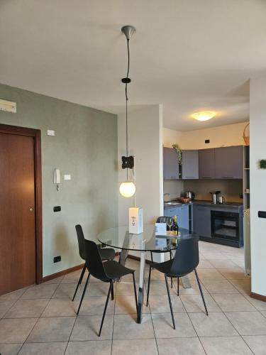 a dining room with a table and chairs in a kitchen at GARDA UN PO' Pool and Lake in Raffa