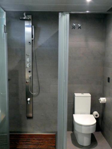 a bathroom with a toilet and a shower at Hotel Villa Paulita in Puigcerdà