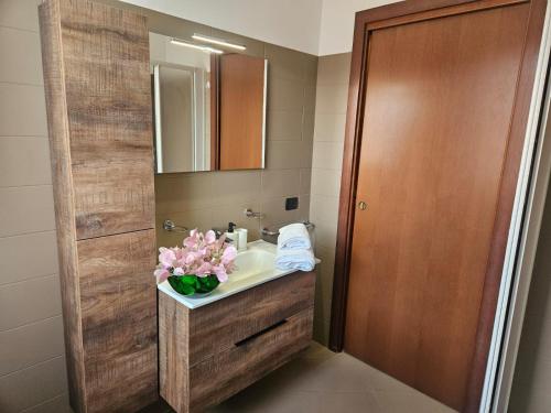 a bathroom with a sink and a mirror at GARDA UN PO' Pool and Lake in Raffa