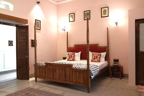 a bedroom with a canopy bed with pillows at House of Amer in Jaipur