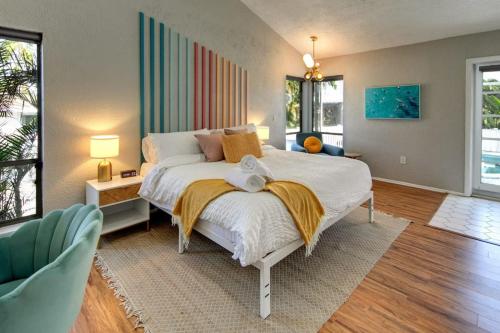 a large bedroom with a large bed and a couch at Funky Flamingo 3Kings Beach Gear Hot Tub & Pool in Bradenton