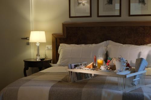 a hotel room with a tray of food on a bed at Residenza Paulonia in Volta Mantovana
