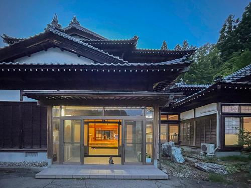 a building with a glass door in front of it at 白華の家 House of Hakka秋田駅秋田空港への送迎可能 in Akita