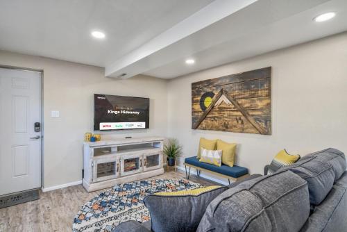 a living room with a couch and a fireplace at Kings Hideaway Stylish Apartment with Scenic View in Colorado Springs