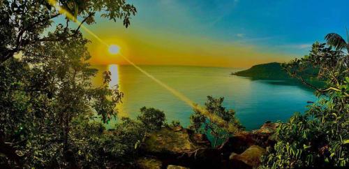 a view of a body of water with a sunset at Sweet Time Bungalows in Koh Rong Sanloem