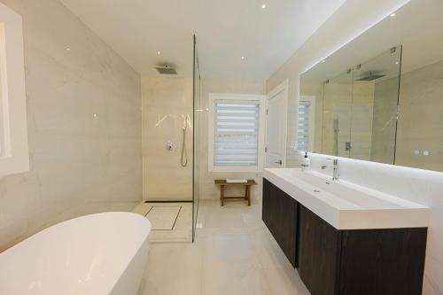 a bathroom with a tub and a sink and a shower at Luxurious Home Away from Home ! 30 minutes to NYC ! in Rochelle Park