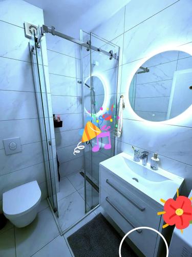 a white bathroom with a sink and a mirror at Apartments Slavica Trogir in Trogir