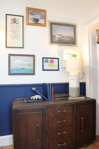 a lamp on top of a dresser in a room at The Old Buoy Inn in Seahouses
