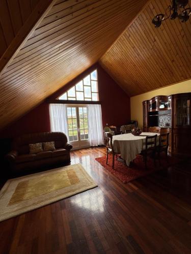 a living room with a table and a couch at Ponta do Sol Villa in Ponta do Sol