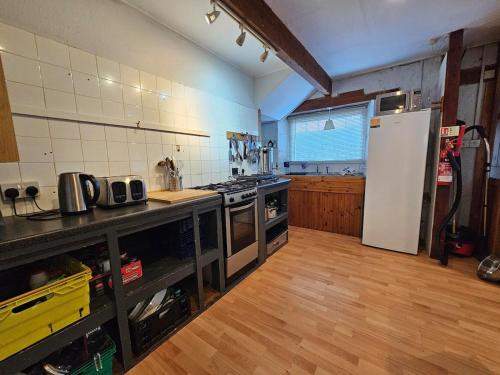 a kitchen with a stove and a refrigerator at Bunkhouse Northumberland in Preston
