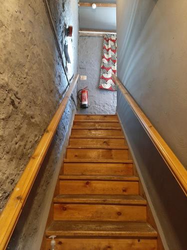 a staircase with wooden steps leading up to a room at Bunkhouse Northumberland in Preston