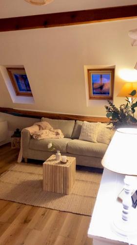 a living room with a couch and a coffee table at La Perle Semuroise in Semur-en-Auxois