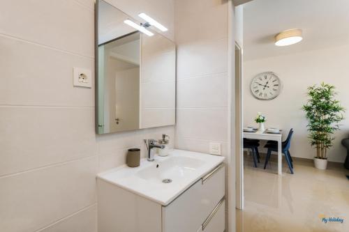 a bathroom with a sink and a mirror and a table at Blue Beach in Playa del Ingles