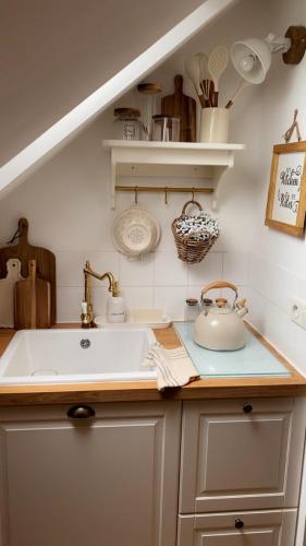 a kitchen with a sink and a counter top at La Perle Semuroise in Semur-en-Auxois