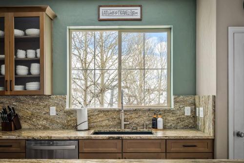 a kitchen with a window above a kitchen sink at Timber Court in Granby