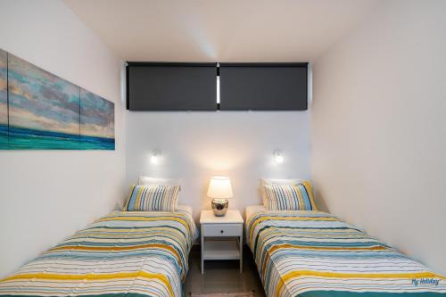 two beds sitting next to each other in a room at Blue Beach in Playa del Ingles