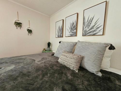 a bedroom with a bed and some pictures on the wall at Yadkin Valley Retreat in Jonesville