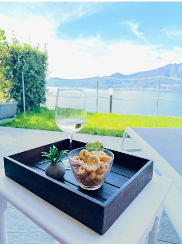 a bowl of food and a glass of wine on a table at Ca' Campitol in Torri del Benaco