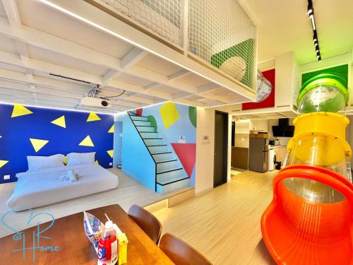 a room with a bed with a colorful wall at Sunway GRID by SR Home in Kampong Pendas