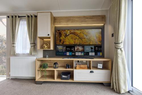 a living room with a flat screen tv on the wall at Billing Aquadrome Holiday Park in Great Billing