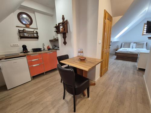 a kitchen and dining room with a table and a bed at Slovenian House Vida in Bled